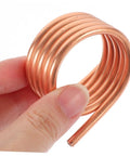 Close-up of copper Boat Motor Cooling Ring Water Cooling Sleeve For RC Yacht 540 Brush Motor Parts, hand holding a coil.