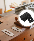Black Stainless Steel Corner Brackets Set Of 10 With Protective Coating on a wooden workbench