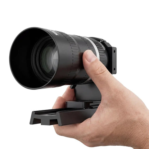 Close-up of Canon RF Mirrorless Astro Telephoto Lens 105mm F2.8 APO held in hand, RF mount adapter visible.