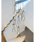 Modern Black Creative Pendant Lamp Pretty Waist LED Light for Duplex Living Room Staircase Loft Restaurant (Colour: 1Light Size: Neutrallight4000K) (8lights Neutrallight4000K) hanging above a staircase.