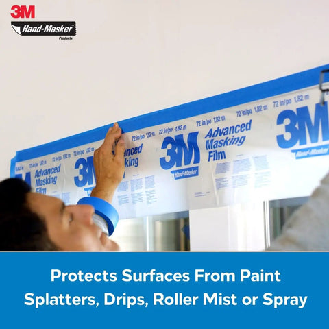 Person applying 3M Hand-Masker film part of Pre Loaded Masking Tape Dispenser Kit With Film For Painting, Drywall Texturing, And Wall Prep