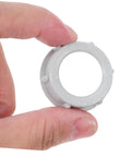 No Fuss 3/4 Inch Plastic Insulating Bushing being held, gray plastic for electrical fittings and strain relief.