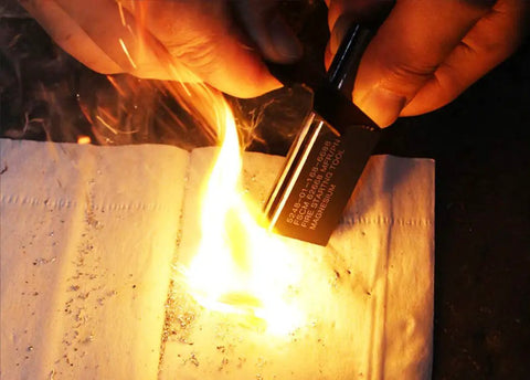 Hands using Magnesium Flint Fire Starter Kit With Striker For Camping And Survival 4 Pack, Easy Spark Generator to ignite fire.