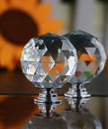 No Hassle Premium Clear Glass Crystal Cabinet Knobs 8 Pack Round Drawer Pulls With Slick Mirror Shine Including Three Mounting Screws For Quick Home Decor Refresh Project, close-up of round crystal cabinet knobs.