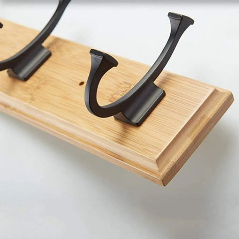 Close-up of Heavy Duty Wall Mount Coat Rack With Seven Rugged Zinc Hooks, showcasing metal hooks on a wooden base.