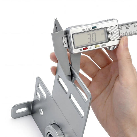 Close-up of a digital caliper measuring a heavy-duty garage door end bearing plate in a Two Pack Garage Door End Bearing Plates And Brackets For 2 Inch Track Doors Heavy Duty Three Eighths Inch Bearing Ends Fits Wood Or Steel Garage Doors Torsion Spring Center Support For Reliable Home Upgrades.