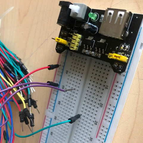DIY Breadboard Kit With Power Supply Module And 65 Jumper Wires 40 Pin 20 Cm Leads Pro Grade Prototyping For 3.3V And 5V Electronics Starter Friendly For Class Lab Or Home Projects Portable And Easy To Use. breadboard with power module and jumper wires on desk