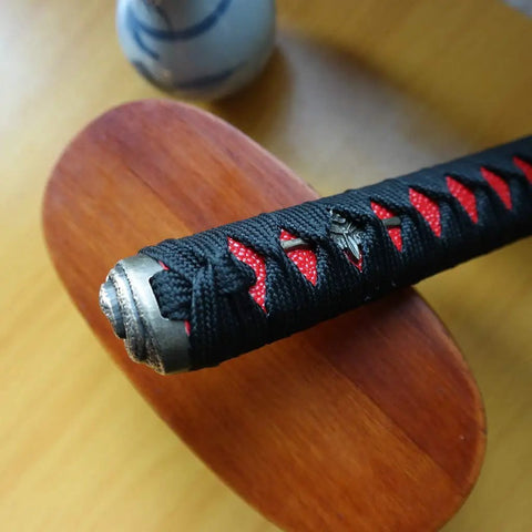 Close-up of Dope DIY Tsuka Sword Handle Kit ten point two inch for samurai katana with black and red silk Ito wrap on hardwood core.