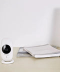 1080P HD Wi-Fi Security Cam With Wide Angle View, Motion Detection, Night Vision, Cloud Backup, And Two-Way Audio on desk