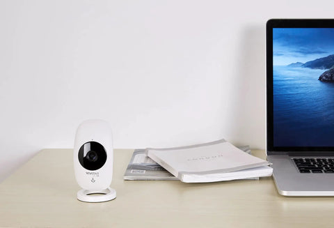 1080P HD Wi-Fi Security Cam With Wide Angle View, Motion Detection, Night Vision, Cloud Backup, And Two-Way Audio on desk