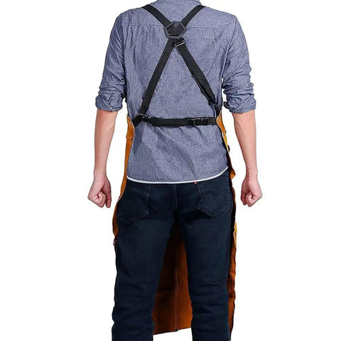 Back view of Leather Welding Apron With Flame Resistant Shield And Six Tool Pockets, cross straps, worn by a person
