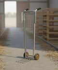 Manual Egg Cart Two Wheel Hand Truck With Front Crate Prongs, Heavy Duty Utility Push Cart Metal Frame, Black Grip Handles, Stable Handling For Stockrooms, Warehouses, Distribution Centers, And Supply Rooms. Front view in warehouse