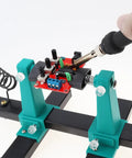 Adjustable PCB Holder Soldering Clamp For Circuit Boards With Soldering Iron Pen Holder And 360 Degree Rotation in use