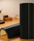 Heavy Duty Self Adhesive Garage Wall Corner Guard With Thick Eva Foam Pad To Shield Your Rig Door From Bad Hits And Bumper Scrapes Quick Peel Stick Edge Padding shown in cylindrical and curved forms on a table.