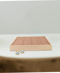Vintage Wood Jewelry Dish With Integrated Smartphone Stand Multi Compartment Accessory Organizer For Rings And Chains on a table with earrings.