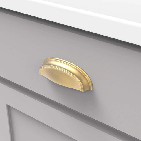 Solid Core Cabinet Pulls In Brushed Golden Brass Finish For Doors And Dresser Drawers, Luxury Hardware With Three Inch And Three Quarter Inch Hole Centers, Length Four And Five Eighths Inch, Width One And A Half Inch, Projection One Inch installed on grey drawer