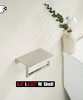 Toilet Paper Holder With Phone Shelf Fits Five Inch Rolls 304 Stainless Steel Brushed Finish Wall Mount Bathroom Organizer Large Six Point Three Inch Shelf For Phones And Small Items No Slip Stop installed on wall next to a vase