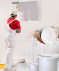 Person in white overalls painting wall; 10 Pack 5 Gallon Paint Strainer Bags With Elastic Drawstring Fine Mesh Filters for Paint