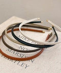 Premium Skinny Leather Headbands For Women Five Piece Set in neutral colors on a book, soft top grain leather.