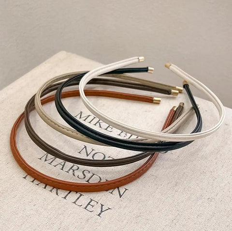 Premium Skinny Leather Headbands For Women Five Piece Set in neutral colors on a book, soft top grain leather.