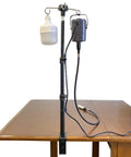 Rock Solid Rotary Tool Stand With Adjustable Height Table Clamp And Flexible Shaft Hook Rack For Dremel Foredom Shops mounted on a table.