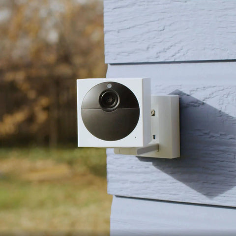 Battery Powered Wire Free Outdoor Security Camera Kit With Base Station 1080P Picture mounted on exterior wall