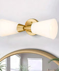 Brushed Gold Vanity Light Fixture Over Mirror With Frosted Milk Glass Sconce displayed above a mirror in modern setting