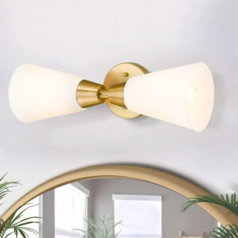 Brushed Gold Vanity Light Fixture Over Mirror With Frosted Milk Glass Sconce displayed above a mirror in modern setting