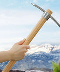 Person holding a 16.5 Inch 2 In 1 Mattock And Pickaxe With Hardwood Handle Stainless Steel Heavy Duty For Digging Hard Soil Prospecting.