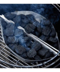 Charcoal burning in a steel grill with Heavy Duty Plated Steel Grill Tool Holder Hooks For 18.5 Inch And 22.5 Inch Charcoal Grills visible.