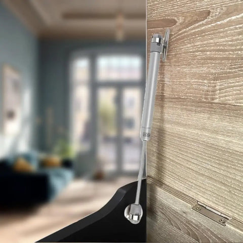Two Pack Soft Close Toy Box Hinges With 100N Gas Strut Safety Lid Support on wood cabinet, matte silver finish.