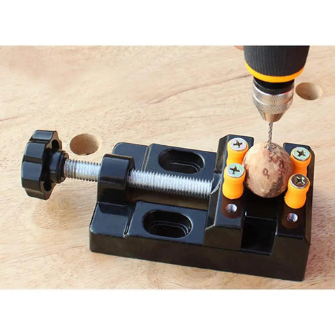 Mini Flat Clamp Bench Vise for Watch Repair and Jewelry DIY holding a round object, ideal for small parts, 0 to 2.1 inches clamp range