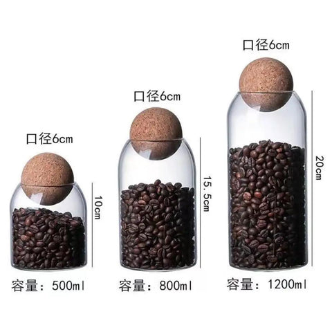 Lock In Freshness Straight Up With This Round Glass Tea Canister Boasting A Tight Cork Seal And Heat Resistant Build Ideal For Storing Coffee Beans Sugar Salt Or Loose Leaves While Looking Sharp On Counters: three sizes, cork tops, filled with coffee beans.