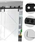 Black Metal Track Connection Plate For Sliding Barn Door Track Fixing Connector displayed in home setting with white barn door.