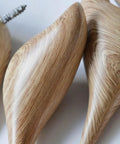 Close-up of the Straight Up Best Bird Shaped Resin Wall Hook With Wood Grain Finish, showing smooth curved edges and texture.