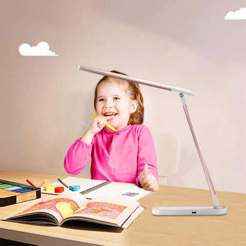 Child smiling with Pink Desk Lamp With USB Charging Port Touch Control 3 Lighting Modes And 3 Brightness Levels Adjustable LED