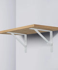 Badass Heavy Duty Metal Shelf Brackets 12 X 8 Inch White L Brackets supporting a wooden shelf on a wall.