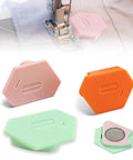 Three hexagonal magnetic seam guides for sewing machines in pink, orange, and mint, with built-in ruler scale.