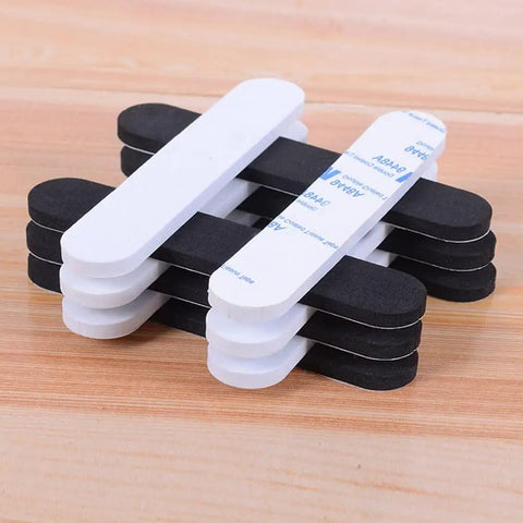 Stack of 30-Piece Hat Size Reducer Tape Set For Hats And Caps, EVA Foam Reducing Strips, black and white, on wooden surface
