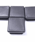 Rock Solid Pack Of Four 1.5 Inch Square Black Plastic Tubing Plugs With Grippy Ribbed Inserts arranged on a white background.