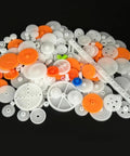 174 Piece Plastic Gear Set For DC Motors And RC Cars Trucks And Robots on black background showing gears and axles