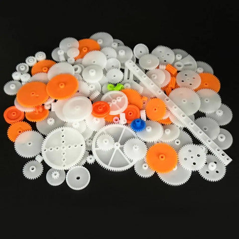 174 Piece Plastic Gear Set For DC Motors And RC Cars Trucks And Robots on black background showing gears and axles