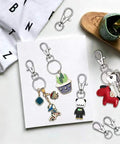 Heavy Duty 104 Piece Swivel Snap Hooks With Silver Lobster Claw Clasps And Keychain Rings For Diy Craft Projects on display with keychains.