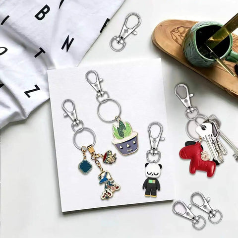 Heavy Duty 104 Piece Swivel Snap Hooks With Silver Lobster Claw Clasps And Keychain Rings For Diy Craft Projects on display with keychains.