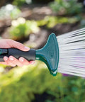 Person using Rain Like Spray Hose Nozzle With Comfort Grip For Garden Watering Durable Metal Body And Rubberized Non Slip Handle