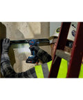 Worker using 18V Brushless Connected-Ready 1/4 In Hex Impact Driver Bare Tool With Auto Bolt Release on construction site wall.