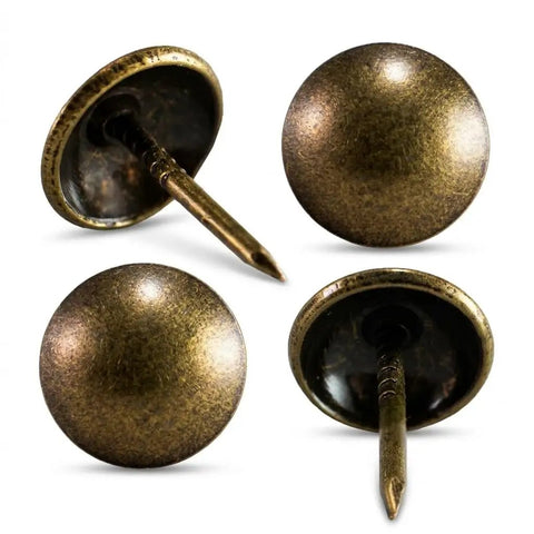 Four antique brass nails from Upholstery Tacks 500 Pack Pro Grade Decorative Furniture Nails for Chairs and Headboards