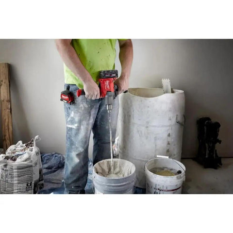 Person using 18V Cordless Mud Mixer Bare Tool for Drywall Mud Plaster and Concrete Projects with buckets and materials
