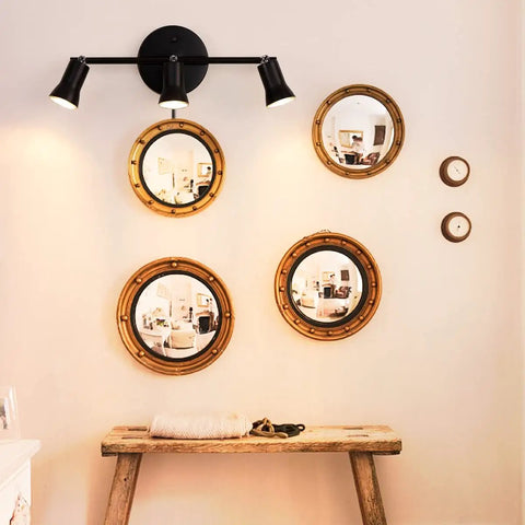 Industrial Track Lighting Kit With Adjustable 3-Light Brass Lamp Holders mounted above a rustic bench and decorative mirrors.
