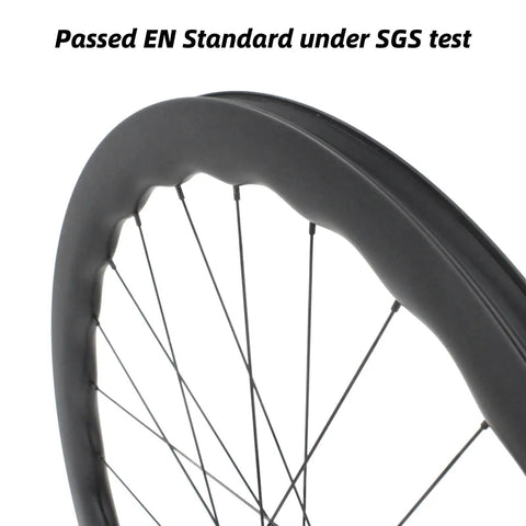 Close-up of carbon fiber road bike wheelset with 50mm depth, tubeless ready, clincher with disc brake and six bolts.